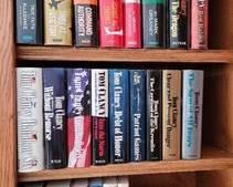 23 hard cover Tom Clancy books with jackets and 4 standard-sized soft cover Tom Clancy books