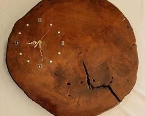 20" diameter tree-truck cross-section battery-operated clock, features a beautifully varnished surface.