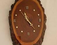 9" x 14 1/2" tree-trunk cross-section battery-operated clock.

This item features a beautifully varnished two-toned wood surface, with a ruff-hewn bark perimeter