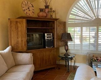 Rustic Entertainment Unit, Iron and Glass End Tables, Iron and Glass Coffee Table, Sofa and Loveseat, Area Rug, Table Lamps, Pottery