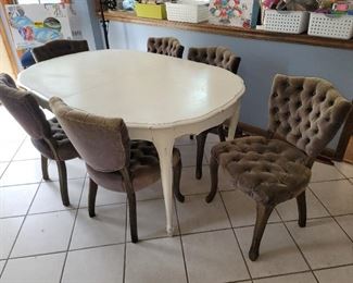 White kitchen table. Green tufted chairs