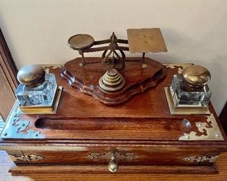 Item 30:  English c. 1870 large brass decorated golden oak desk set incorporating postal scales and weights.  Set with crystal inks and with a drawer below - 17.25"l x 10.25"w x 8"h: $1050