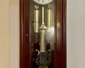 Item 86:  Sligh Wellington Well-maintained Solid Mahogany case with beveled glass front and sides. Gridiron brass pendulum with Black Forest clock movement- 23.25"l x 13"w x 67"h: $695