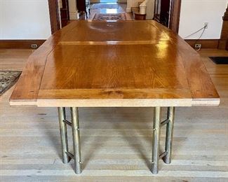 Item 127:  Waterfront Designs Oak Table with Brass Legs (table pad included) - 98"l x 52.75"w x 31"h:  $695                                                                      