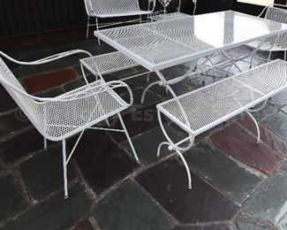 Metal outdoor table with two armchairs and two bench seats. includes custom-cut plexiglass tabletop. 
