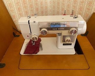 New Home sewing machine in cabinet 
