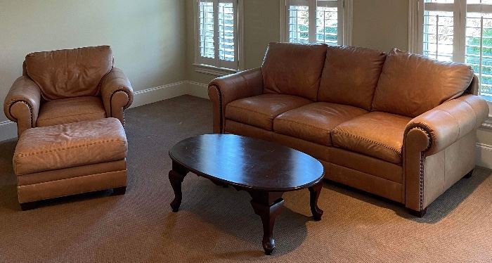 Leather sofa chair and ottoman along with coffee table