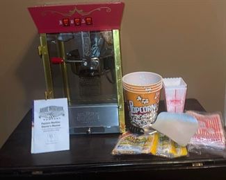 Great northern popcorn company machine with supplies and manual. Three years old. Measures about 30 inches high by 18 inches wide by 18 inches in diameter. Has some supplies with it