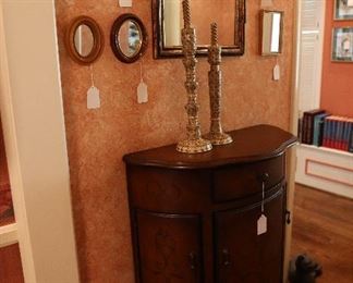 mirrors, candle holders, small antique cupboard