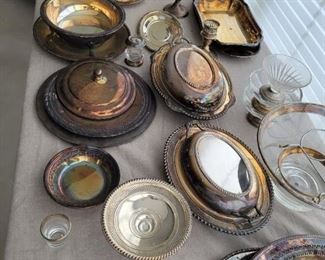 Sterling and Silver Plated Lot -Weighted Sterling-NS Co Candlesticks -Sterling International Salt and pepper shakers -Weighted sterling Cornwall dish -Wallace silver plated dishes and plate -Oneida Silver Plated platter -Sterling larger candlesticks -Glass and silver plated custard dishes and bowls -Silver plated casserole server with glass insert -Glass and silver plated candlestick, shot glass, and pepper shaker