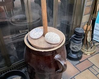 . . . an authentic stoneware butter  churn -- notice vintage lantern to the right and fireplace tool set