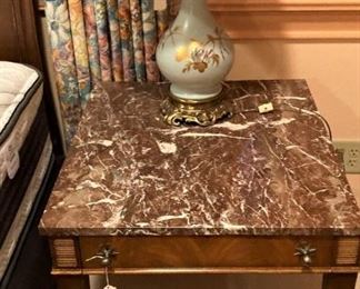 One of two marble top side tables; one of two delicate lamps
