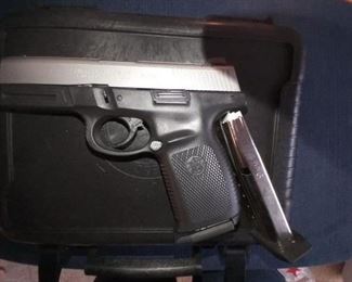 Smith & Wesson 9mm, SW9VE double action pistol (two-tone), spare magazine, and case.