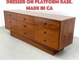 Lot 338 Exotic wood Triple dresser on platform base. Made in Ca