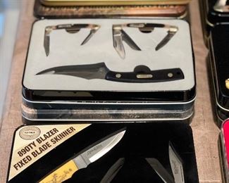 Very large selection of commemorative knife sets.