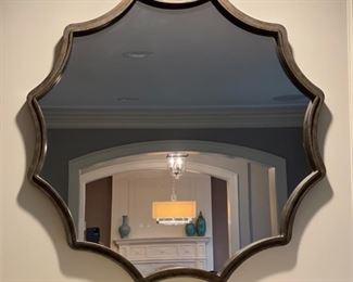 Wavy decorative mirror. Measures 34" D.