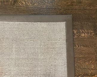 Neutral rug with leather trim. Measures 11' 6" x 12' 7". Photo 2 of 2.