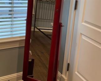 Stand-alone dressing mirror/ jewelry cabinet. Measures 57" H x 17" W.