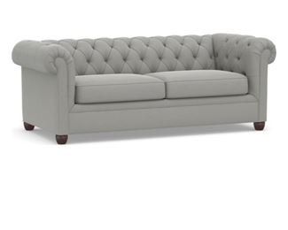 Linen upholstered Chesterfield sofa. Measures 89" W x 34" D x 30" H.