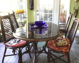 Bamboo dining table with glass top and four chairs