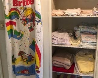 Rainbow Brite beach towel, assorted sheets (twin & queen), a few towels, rag rugs