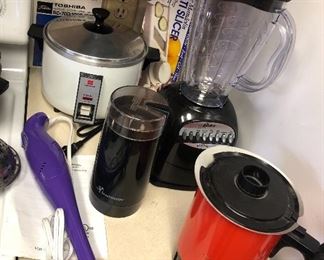 Small appliances: rice cooker, coffee grinder, purple immersion blender, Oster blender, West Bend hot pot