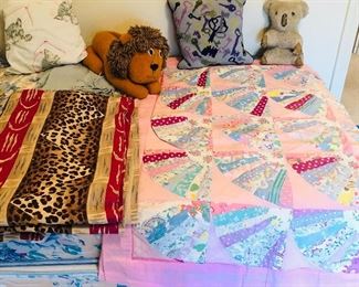 Clarence House tropical “Mozambique” linen fabric (piece is 55” x 99”), flour sack quilt (46” x 64”), vintage stuffed animals, needlepoint pillow