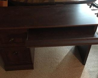 Solid wood computer desk with 2 drawers, keyboard tray and hideaway cord storage. 