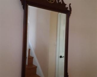 Wooden Wall Mirror with Brass Accents and Floral Centerpiece