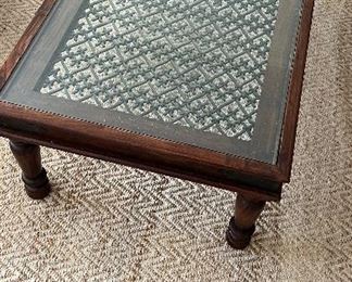 Wood, Iron and Glass Coffee Table from AT HOME, in Homewood. Dark wood frame with black iron corner accents and an ornate iron grate covered by glass. Height: 18". Width: 54". Depth: 30". PRICE $150