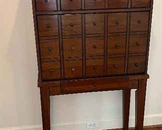 Pottery Barn Apothecary Drop Front Secretary Desk. Front opens to make a desk with hidden storage drawers. Small storage drawer on Base and above desk opening. Height: 62". Width: 32.5". Depth: 16". PRICE $800