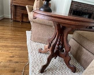 Victorian walnut oval side table. H: 28". W: 30". D: 22" PRICE $125