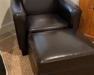 Black Vegan leather club chair and storage ottoman H: 33". W: 22". D: 29". Ottoman H: 15". W: 25". D: 22". PRICE $300