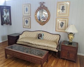 Pair of hand-carved wood Asian-themed end tables and matching coffee table, Vintage Easter egg yellow silk upholstered sofa (goose down 75%, goose feathers 25%) by Cocheo Brothers, set/4 beautifully framed/filleted Grecian urn lithographs, amazing gold gilt bullseye mirror, w/eagle topper and hanging mahogany display cabinet. 