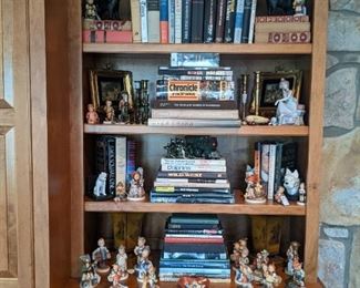 Built-in, with books a-plenty, Lladro figurine, cast iron items, antlers and decent Hummel figurine collection.