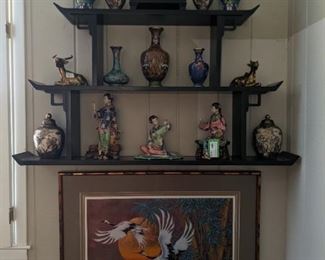 Vintage black lacquer Asian pagoda wall shelf (measures 7" D x 44" W x 24" T) with wonderful collection of cloisonne vases, artist signed Asian porcelain women and nicely framed/matted Asian cranes, in faux bamboo frame.