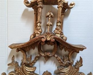 Close-up, top detail of the gold gilt Chinoiserie wall mirror.