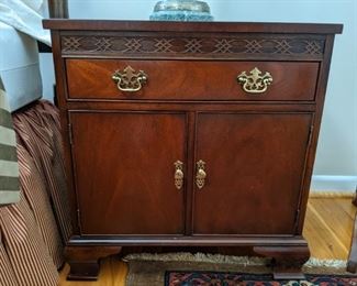 Close-up of one of the pair of  Baker mahogany bedside chests.