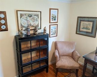 Vintage Macey #711 black lacquer 3-level barrister bookcase on legs, vintage framed map print, barometer and comfy armchair.