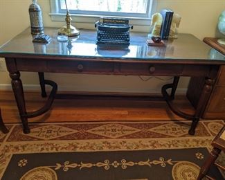 Vintage mahogany Gregory Mayer & Thom desk, Detroit, MI, with glass top, vintage Underwood "Noiseless" typewriter, onyx horse head bookends and green glass shade desk lamp.