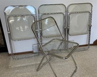 Plia Acrylic/steel folding chairs.  