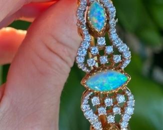 L - $2,350 - Opal & Diamonds bracelet. Ladies 14kt yellow bangle bracelet set with 3 marquise shaped opals that measure 12x6mm, 10x5mm, & 10x5mm. Total of 1.5 ct of round diamonds mele. Color : G/H. Clarity Si-1/2. All stones are natural and prone set. 31 grams. Appraisal included. 