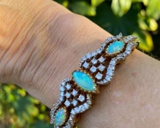L - $2,350 - Opal & Diamonds bracelet. Ladies 14kt yellow bangle bracelet set with 3 marquise shaped opals that measure 12x6mm, 10x5mm, & 10x5mm. Total of 1.5 ct of round diamonds mele. Color : G/H. Clarity Si-1/2. All stones are natural and prone set. 31 grams. Appraisal included. 