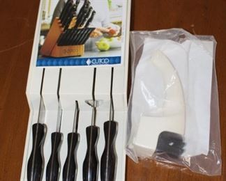 Cutco knife set shown with sharpener.