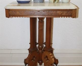 Victorian marble top table shown with studio art pottery.