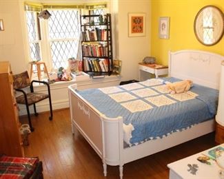 Bedroom has a beautiful painted full size bed, books, misc. furniture and lots of wall art.  