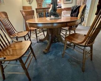 Turn of the century round oak pedestal table applied carving on base, one leaf