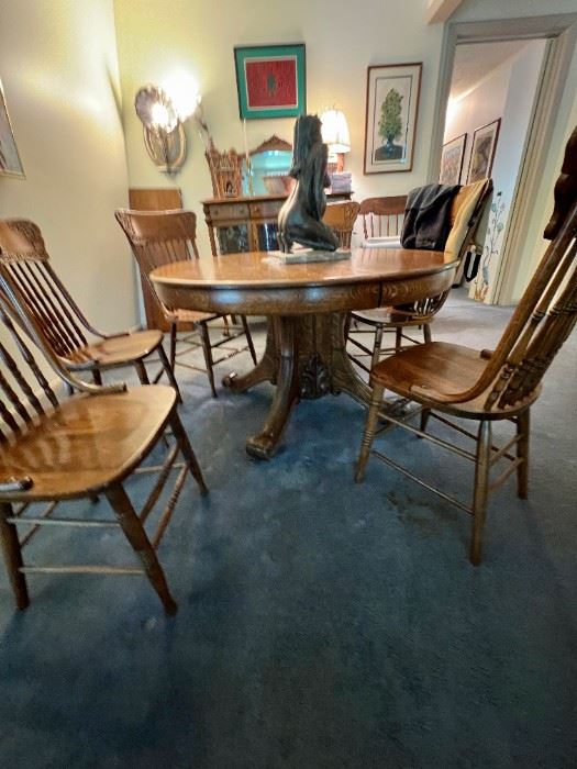 Turn of the century round oak pedestal table applied carving on base, one leaf