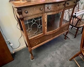 Turn of the century quarter sawn oak buffet with beveled mirrors and leaded Glass windows.