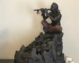 Native American playing his flute. Very charming sculpture.